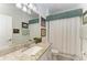 Bathroom featuring granite countertop, framed mirror, and decorative wall art at 15917 Clear Skies Pl, Lakewood Ranch, FL 34211