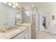Stylish bathroom with glass shower door, granite countertops, and double mirrors at 15917 Clear Skies Pl, Lakewood Ranch, FL 34211