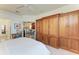Well-appointed bedroom with a custom wooden closet that connects to living room at 15917 Clear Skies Pl, Lakewood Ranch, FL 34211