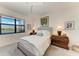 Well-lit bedroom with a view of the lake and decorative lamps on nightstands at 15917 Clear Skies Pl, Lakewood Ranch, FL 34211