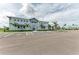 Exterior of the neighborhood clubhouse with ample parking surrounded by manicured tropical landscaping at 15917 Clear Skies Pl, Lakewood Ranch, FL 34211