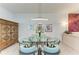 Dining room with a glass top table and contemporary light fixture at 15917 Clear Skies Pl, Lakewood Ranch, FL 34211