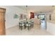 Open-concept dining room with a glass table and chairs, adjacent to the kitchen at 15917 Clear Skies Pl, Lakewood Ranch, FL 34211