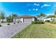 Charming single-story home featuring a tile roof, landscaped yard, and a spacious three-car garage at 15917 Clear Skies Pl, Lakewood Ranch, FL 34211