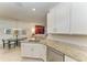 Open kitchen with granite countertops and stainless steel dishwasher flows into living area at 15917 Clear Skies Pl, Lakewood Ranch, FL 34211