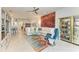 Spacious living room with tile floors, colorful rug, and comfortable seating arrangement at 15917 Clear Skies Pl, Lakewood Ranch, FL 34211