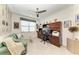Home office with a comfortable sofa, built-in desk, and custom shelving at 15917 Clear Skies Pl, Lakewood Ranch, FL 34211