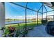 Enjoy the view from this screened patio with brick flooring and outdoor accents at 15917 Clear Skies Pl, Lakewood Ranch, FL 34211