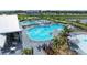 A gorgeous luxury community pool area with sun loungers, umbrellas, and tropical landscaping at 15917 Clear Skies Pl, Lakewood Ranch, FL 34211