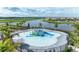Fun splash pad featuring colorful play structures, slides, and a beautiful lake view in the distance at 15917 Clear Skies Pl, Lakewood Ranch, FL 34211