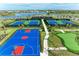 Community amenities showcasing colorful tennis and basketball courts next to putting green surrounded by palm trees at 15917 Clear Skies Pl, Lakewood Ranch, FL 34211