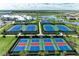 Aerial view of well-maintained tennis and pickleball courts at a community near the lake at 15917 Clear Skies Pl, Lakewood Ranch, FL 34211