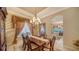 Bright dining room with a view into the kitchen, showcasing a formal table setting at 1712 Grande Park Dr, Englewood, FL 34223