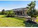 Landscaped backyard with screened pool and lush greenery at 17459 Hickok Belt Loop, Bradenton, FL 34211