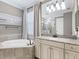 Bathroom with a large vanity, soaking tub, and separate shower at 17459 Hickok Belt Loop, Bradenton, FL 34211