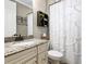 Charming bathroom with granite countertop, updated vanity, and decorative shower curtain at 17459 Hickok Belt Loop, Bradenton, FL 34211