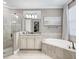 Elegant bathroom with soaking tub, walk-in shower, and granite vanity at 17459 Hickok Belt Loop, Bradenton, FL 34211