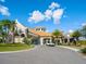 Community clubhouse with Mediterranean architecture and ample parking at 17459 Hickok Belt Loop, Bradenton, FL 34211
