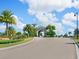 Gated community entrance with palm trees and arched entryway at 17459 Hickok Belt Loop, Bradenton, FL 34211