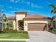 Attractive single-story home with a tile roof, landscaped yard, and two-car garage at 17459 Hickok Belt Loop, Bradenton, FL 34211