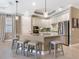 Modern kitchen with granite island, stainless steel appliances, and white cabinets at 17459 Hickok Belt Loop, Bradenton, FL 34211