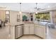 Island kitchen with granite countertops, stainless steel dishwasher, and white cabinets at 17459 Hickok Belt Loop, Bradenton, FL 34211