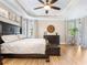 Main bedroom with large bed, hardwood floors, and plenty of natural light at 17459 Hickok Belt Loop, Bradenton, FL 34211