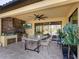 Outdoor kitchen with built-in grill, concrete countertop, and ceiling fan at 17459 Hickok Belt Loop, Bradenton, FL 34211