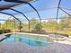 Relaxing pool and spa area with screened enclosure and lush landscaping at 17459 Hickok Belt Loop, Bradenton, FL 34211