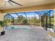 Relaxing screened pool and spa with view of lush landscaping at 17459 Hickok Belt Loop, Bradenton, FL 34211