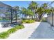 Landscaped backyard with gravel path and tropical foliage at 18 N Casey Key Rd, Osprey, FL 34229