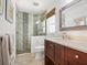 Updated bathroom with a pebble tile shower and modern vanity at 18 N Casey Key Rd, Osprey, FL 34229