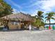Relaxing beach bar with thatched roof and colorful seating at 18 N Casey Key Rd, Osprey, FL 34229