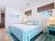 King bedroom with coastal bedding and access to the pool at 18 N Casey Key Rd, Osprey, FL 34229