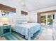 King-size bed, serene decor, and pool view from this bedroom at 18 N Casey Key Rd, Osprey, FL 34229