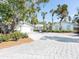 Attractive home with a large, paved driveway and lush landscaping at 18 N Casey Key Rd, Osprey, FL 34229