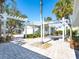 Landscaped front yard with attractive pergolas and brick pavers at 18 N Casey Key Rd, Osprey, FL 34229