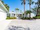 House exterior with a paver driveway and lush landscaping at 18 N Casey Key Rd, Osprey, FL 34229