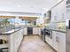 Modern kitchen featuring stainless steel appliances and granite countertops at 18 N Casey Key Rd, Osprey, FL 34229