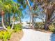 Lovely pathway meanders through lush tropical landscaping, leading to the home at 18 N Casey Key Rd, Osprey, FL 34229