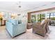 Living room with pool view and comfortable seating at 18 N Casey Key Rd, Osprey, FL 34229