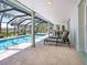 Relaxing pool area with lounge chairs and screened enclosure at 18 N Casey Key Rd, Osprey, FL 34229
