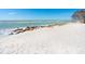 White sand beach with rocky shoreline and calm ocean waves at 18 N Casey Key Rd, Osprey, FL 34229
