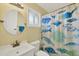 Bathroom with white vanity and fun shower curtain at 1815 Vera Pl # 9, Sarasota, FL 34235