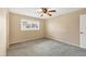 Well-lit bedroom featuring grey carpet and a ceiling fan at 1815 Vera Pl # 9, Sarasota, FL 34235