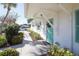 Community building exterior with teal door and landscaping at 1815 Vera Pl # 9, Sarasota, FL 34235
