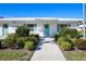 Community building with teal door and manicured landscaping at 1815 Vera Pl # 9, Sarasota, FL 34235