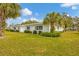 Single story home with white exterior and palm trees at 1815 Vera Pl # 9, Sarasota, FL 34235