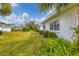 Building exterior showcasing manicured lawn and lush landscaping at 1815 Vera Pl # 9, Sarasota, FL 34235