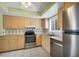 Bright kitchen with stainless steel appliances and light wood cabinets at 1815 Vera Pl # 9, Sarasota, FL 34235